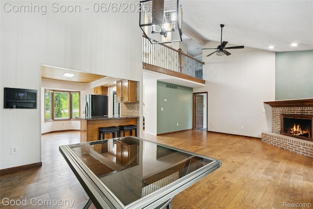 5490 Clarkston Rd, Clarkston, MI 48348 - kitchen with freestanding refrigerator, high vaulted ceiling, ceiling fan, hardwood / wood-style floors, and baseboards