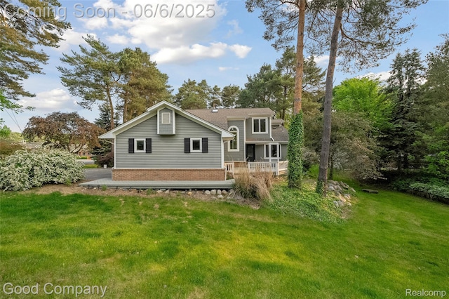 5490 Clarkston Rd, Clarkston, MI 48348 - back of property featuring a yard, brick siding, and a wooden deck