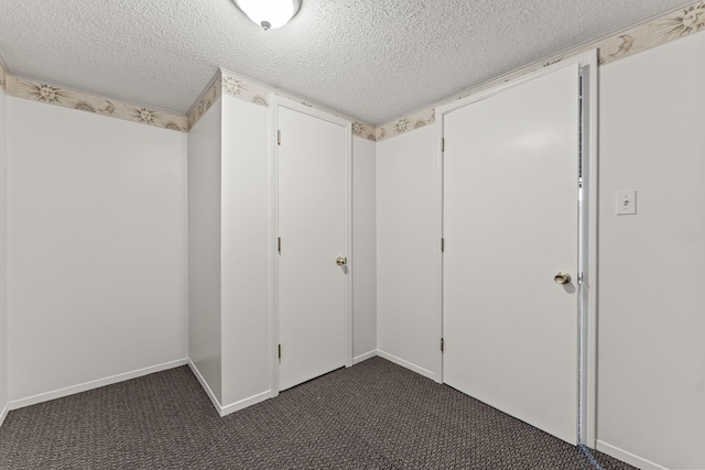 21850 Schroeder Ave, Eastpointe, MI 48021 - interior space with a textured ceiling, dark carpet, and baseboards