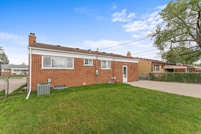 21850 Schroeder Ave, Eastpointe, MI 48021 - back of house featuring a chimney, brick siding, central air condition unit, and a patio area