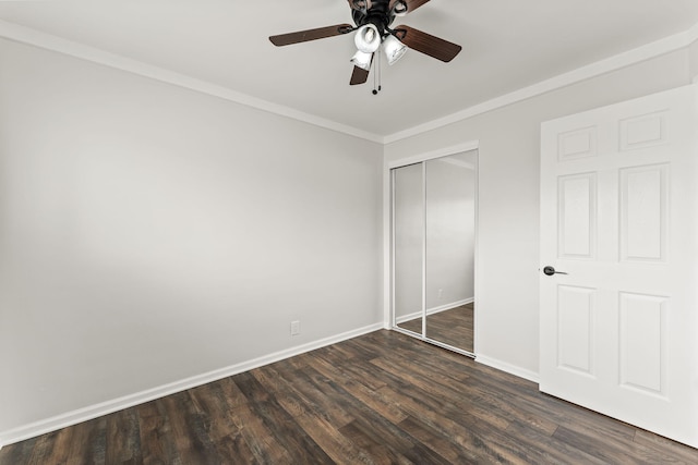 21850 Schroeder Ave, Eastpointe, MI 48021 - unfurnished bedroom featuring a closet, baseboards, dark wood-type flooring, crown molding, and ceiling fan