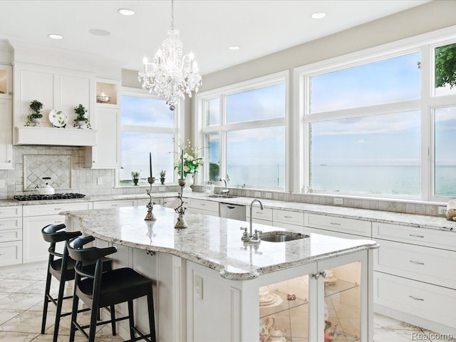 4326 Gratiot Ave, Port Huron, MI 48060 - kitchen featuring a sink, light marble finish flooring, a center island with sink, healthy amount of natural light, and recessed lighting