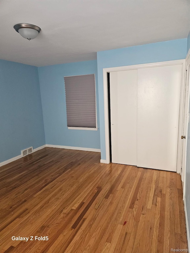 18941 Puritan St, Detroit, MI 48223 - unfurnished bedroom with wood finished floors, a closet, and baseboards
