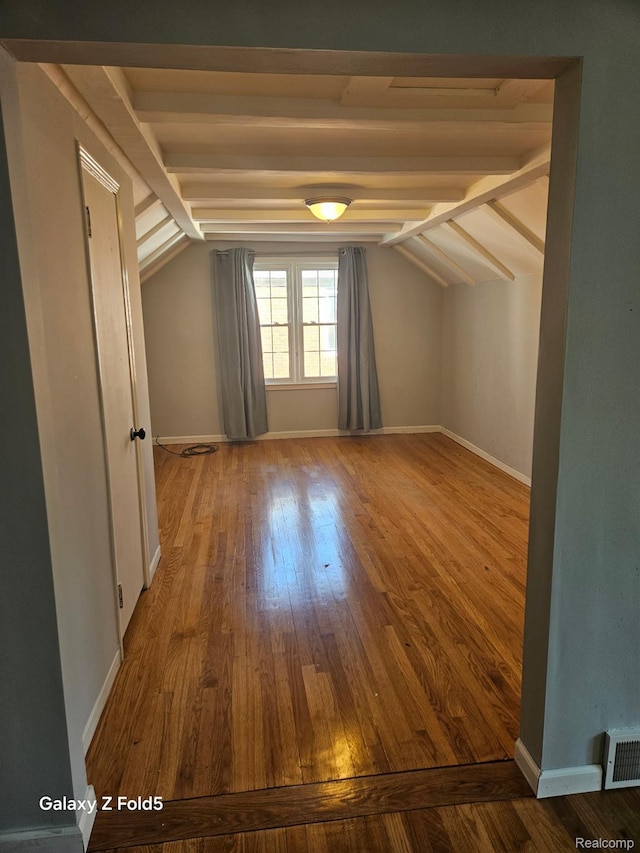 18941 Puritan St, Detroit, MI 48223 - additional living space with vaulted ceiling, wood-type flooring, and baseboards