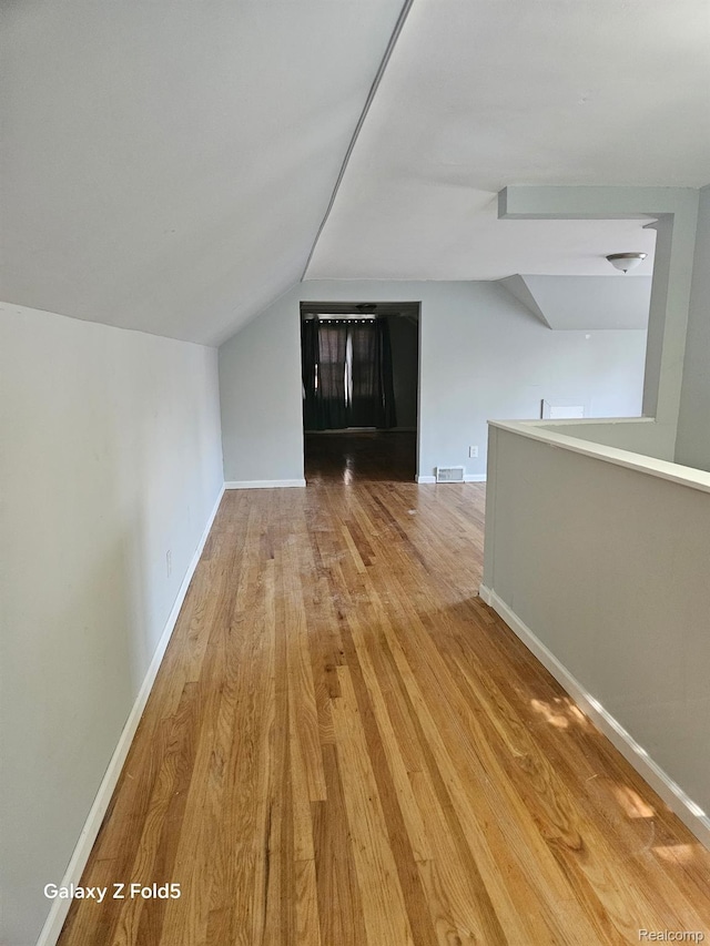 18941 Puritan St, Detroit, MI 48223 - additional living space with wood finished floors, lofted ceiling, and baseboards