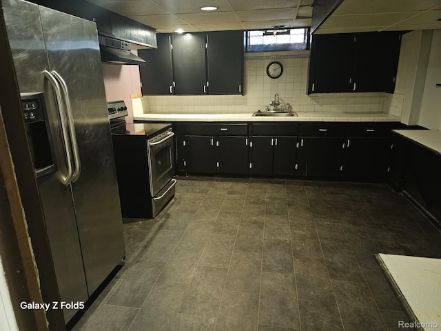 18941 Puritan St, Detroit, MI 48223 - kitchen with stainless steel appliances, dark cabinets, under cabinet range hood, a sink, and tile countertops