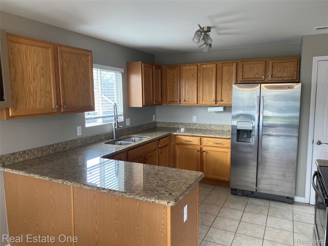 29337 Woodpark Cir Unit 60, Warren, MI 48092 - kitchen with stainless steel fridge with ice dispenser, a peninsula, brown cabinetry, and dark stone counters