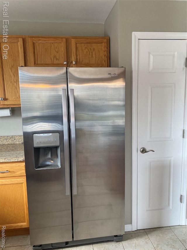 29337 Woodpark Cir Unit 60, Warren, MI 48092 - kitchen with stainless steel refrigerator with ice dispenser, brown cabinets, and light tile patterned flooring