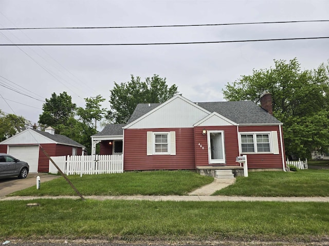 460 Westcombe Ave, Flint, MI 48503 - view of front facade with a chimney, a garage, and roof with shingles