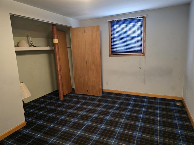 460 Westcombe Ave, Flint, MI 48503 - unfurnished bedroom with carpet flooring, baseboards, and a closet