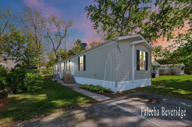 2575 Theodore Ave, Hudsonville, MI 49426 - view of property exterior with entry steps and a yard