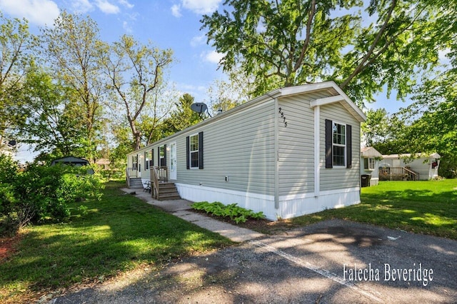 2575 Theodore Ave, Hudsonville, MI 49426 - view of home's exterior featuring entry steps and a yard