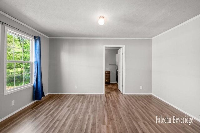 2575 Theodore Ave, Hudsonville, MI 49426 - spare room featuring wood finished floors, crown molding, a textured ceiling, and baseboards