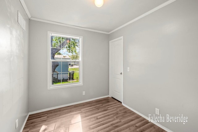 2575 Theodore Ave, Hudsonville, MI 49426 - empty room with ornamental molding, wood finished floors, and baseboards