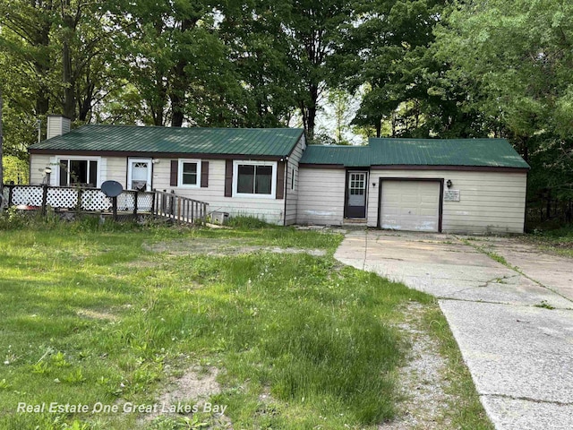8446 Bamfield Rd, South Branch, MI 48761 - ranch-style home featuring concrete driveway, a garage, a chimney, and metal roof
