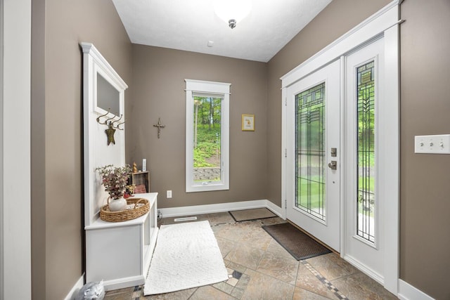 1708 N Norris Rd, Middleville, MI 49333 - doorway to outside with baseboards and stone tile floors