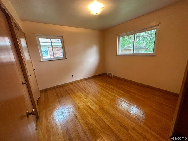 28876 Palm Beach Dr, Warren, MI 48093 - empty room with light wood-style floors, healthy amount of natural light, and baseboards