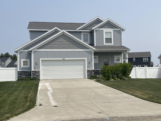 3880 Elm Ridge Dr, Holland, MI 49424 - craftsman-style home with board and batten siding, concrete driveway, stone siding, a shingled roof, and a gate