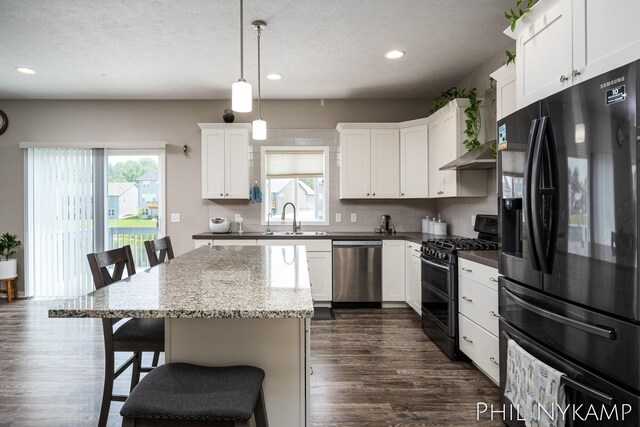 3880 Elm Ridge Dr, Holland, MI 49424 - kitchen featuring black refrigerator with ice dispenser, dishwasher, range with two ovens, a sink, and recessed lighting