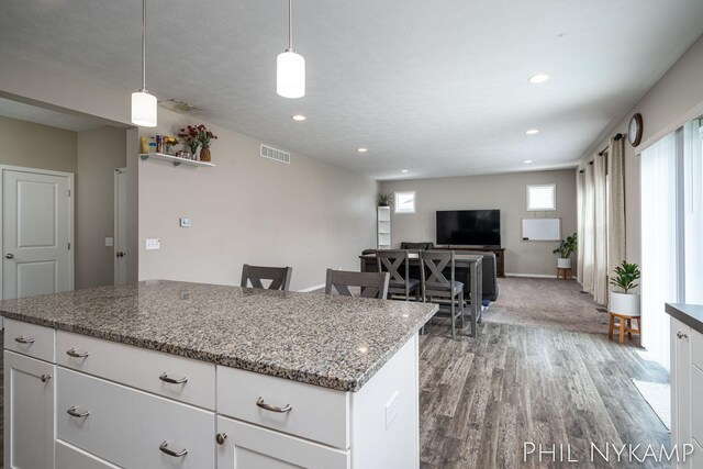 3880 Elm Ridge Dr, Holland, MI 49424 - kitchen featuring light wood-type flooring, a center island, white cabinetry, recessed lighting, and light stone counters
