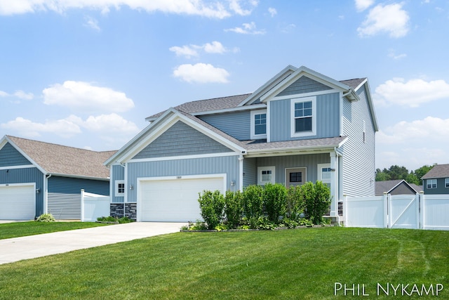 3880 Elm Ridge Dr, Holland, MI 49424 - craftsman inspired home with concrete driveway, an attached garage, board and batten siding, a gate, and roof with shingles
