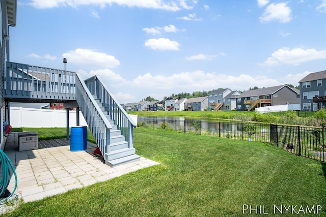 3880 Elm Ridge Dr, Holland, MI 49424 - view of yard featuring a residential view, stairs, a patio area, and a water view