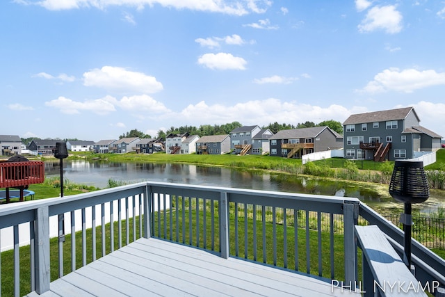 3880 Elm Ridge Dr, Holland, MI 49424 - deck with a residential view, a water view, and a lawn