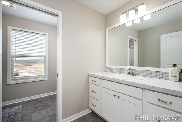 3880 Elm Ridge Dr, Holland, MI 49424 - bathroom with vanity, tasteful backsplash, and baseboards