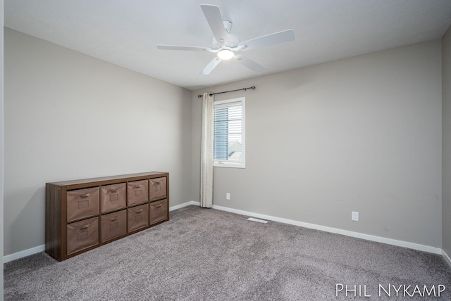 3880 Elm Ridge Dr, Holland, MI 49424 - unfurnished bedroom featuring carpet, baseboards, and ceiling fan