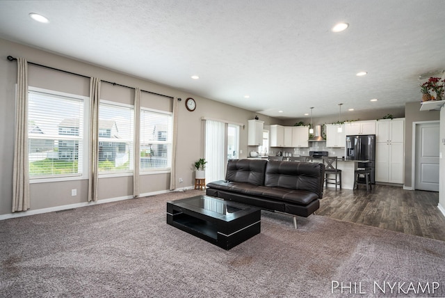 3880 Elm Ridge Dr, Holland, MI 49424 - living room featuring recessed lighting, baseboards, and dark carpet