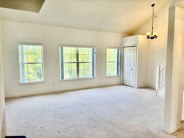 1870 Lindsay Ln, Ann Arbor, MI 48104 - carpeted spare room featuring healthy amount of natural light, a chandelier, lofted ceiling, and stairs