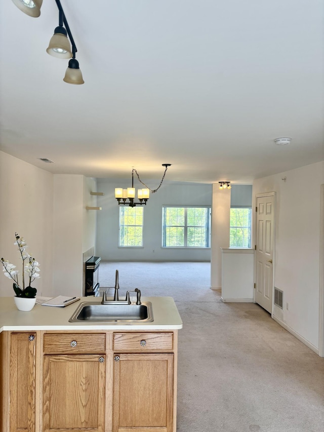 1870 Lindsay Ln, Ann Arbor, MI 48104 - kitchen with open floor plan, a sink, light carpet, light countertops, and a chandelier
