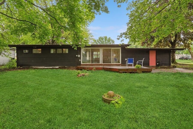 457 Gary Ave, Benton Harbor, MI 49022 - rear view of property with a lawn, a sunroom, concrete driveway, and an attached garage