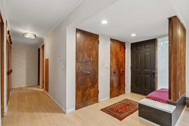 457 Gary Ave, Benton Harbor, MI 49022 - foyer entrance with light wood-style flooring, baseboards, brick wall, and recessed lighting