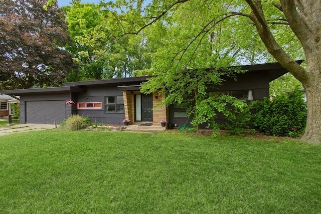 457 Gary Ave, Benton Harbor, MI 49022 - view of front of home featuring a front lawn, a garage, and concrete driveway