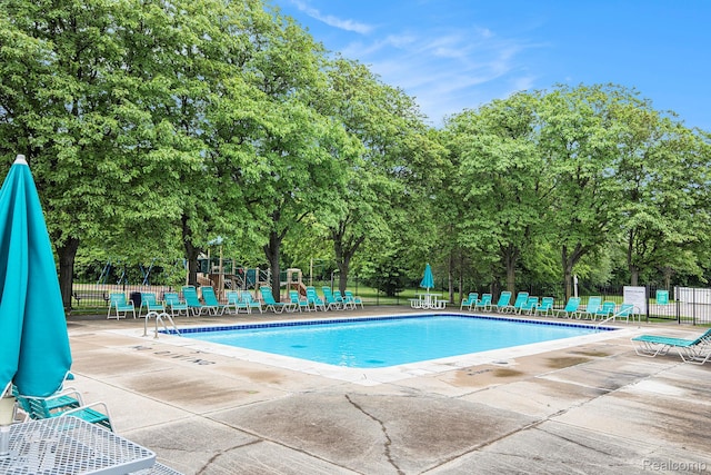 57911 Lancaster Rd, Washington, MI 48094 - community pool with a patio area and view of wooded area
