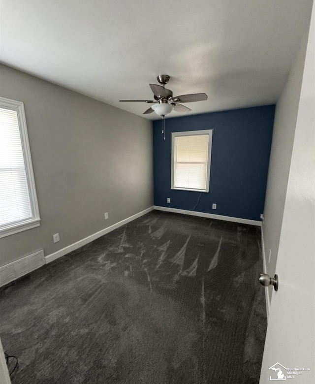 17765 Ruth St, Melvindale, MI 48122 - spare room featuring dark carpet, a ceiling fan, and baseboards