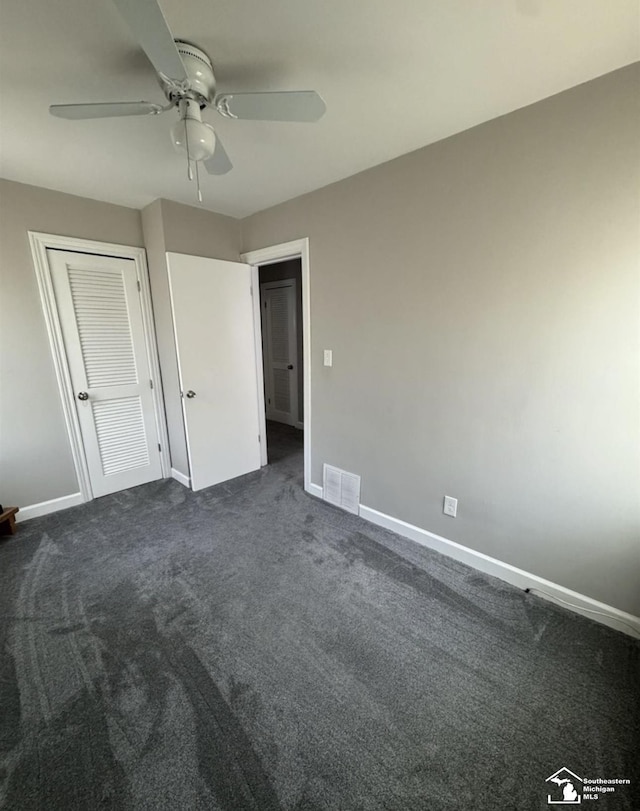 17765 Ruth St, Melvindale, MI 48122 - unfurnished bedroom with baseboards, dark carpet, ceiling fan, and a closet