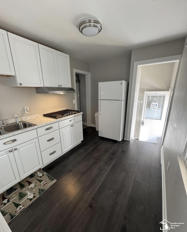 17765 Ruth St, Melvindale, MI 48122 - kitchen featuring freestanding refrigerator, under cabinet range hood, stainless steel gas cooktop, a sink, and white cabinets