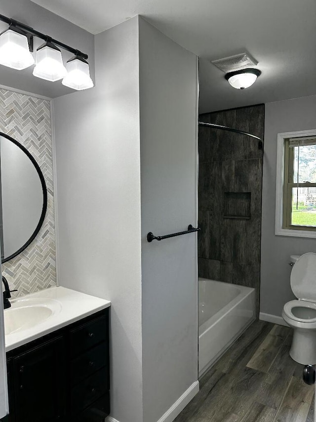 775 Riverview Dr, Plainwell, MI 49080 - full bath with toilet, vanity, backsplash, wood finished floors, and shower / tub combination