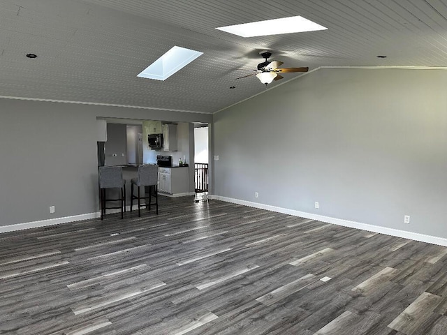 775 Riverview Dr, Plainwell, MI 49080 - unfurnished living room with a skylight, dark wood-style floors, baseboards, ceiling fan, and vaulted ceiling
