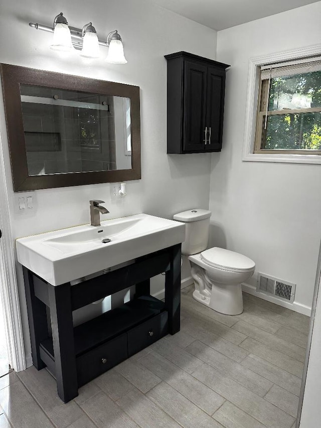 775 Riverview Dr, Plainwell, MI 49080 - full bath featuring baseboards, wood finished floors, toilet, vanity, and a shower