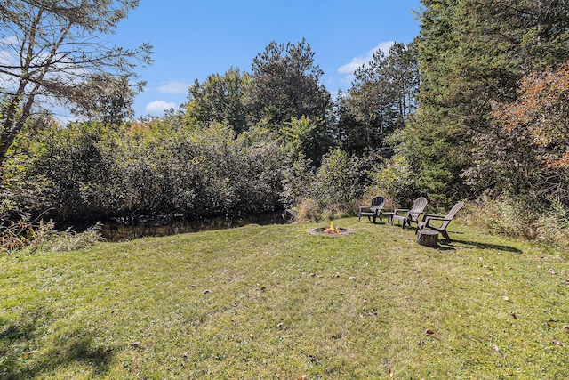 3459 N Morrie Ln, White Cloud, MI 49349 - view of grassy yard featuring an outdoor fire pit