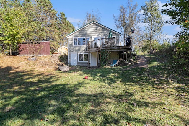 3459 N Morrie Ln, White Cloud, MI 49349 - rear view of house with a deck and a lawn