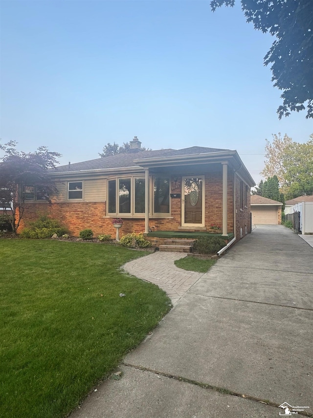 8691 Louise St, Allen Park, MI 48101 - ranch-style home with a front yard, brick siding, a detached garage, and a chimney
