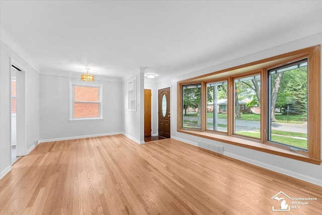 8691 Louise St, Allen Park, MI 48101 - foyer entrance with baseboards, light wood finished floors, and a chandelier