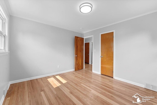 8691 Louise St, Allen Park, MI 48101 - unfurnished room with light wood-type flooring, baseboards, and crown molding