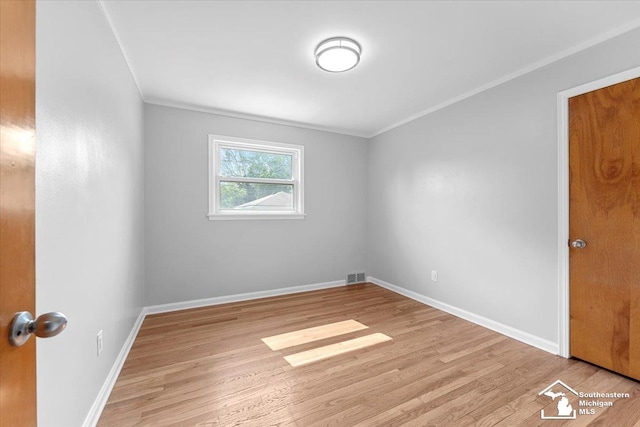 8691 Louise St, Allen Park, MI 48101 - empty room with ornamental molding, light wood finished floors, and baseboards