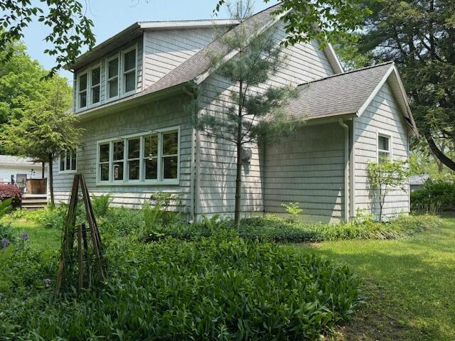 285 Scott St, Newaygo, MI 49337 - view of side of home with roof with shingles and a deck