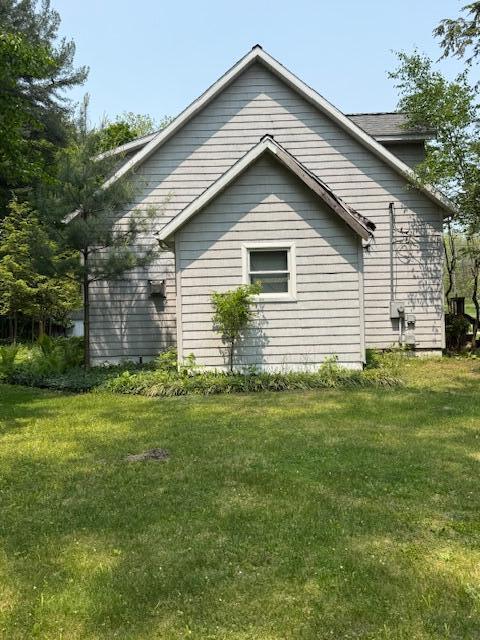 285 Scott St, Newaygo, MI 49337 - view of home's exterior featuring a lawn